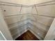 A spacious walk-in closet featuring multiple wire shelves for maximum storage capacity and wood floor at 2422 Brown Dove Way Lot 70, Grayson, GA 30017