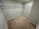 A carpeted walk-in closet featuring one shelf for storage at 2422 Brown Dove Way Lot 70, Grayson, GA 30017