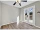 Sunny bedroom with modern wood floors and french doors to the backyard deck at 4810 Winding Ln, Powder Springs, GA 30127