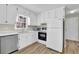 Efficient kitchen featuring white cabinets, stainless steel appliances, and modern lighting at 4810 Winding Ln, Powder Springs, GA 30127