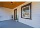 Bright front porch with wood ceiling, modern door, and potted plants at 1006 Byron Sw Dr, Atlanta, GA 30310