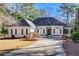 White one-story house with gray roof, black shutters, and a paved driveway at 1260 Lakehaven Pkwy, Mcdonough, GA 30253