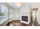 Cozy corner fireplace with marble surround in a sunlit room at 1260 Lakehaven Pkwy, Mcdonough, GA 30253