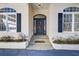 House entrance with dark blue door, stone steps, and white columns at 1260 Lakehaven Pkwy, Mcdonough, GA 30253