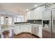 Modern kitchen with white cabinets, granite countertops, and stainless steel appliances at 1260 Lakehaven Pkwy, Mcdonough, GA 30253