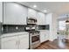 Modern kitchen with white cabinets, granite countertops, and stainless steel appliances at 1260 Lakehaven Pkwy, Mcdonough, GA 30253