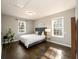 Serene bedroom with gray headboard, hardwood floors, and large windows at 2107 Penrose Dr, Atlanta, GA 30344