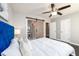 Main bedroom with blue velvet headboard, barn door to en-suite bathroom at 2107 Penrose Dr, Atlanta, GA 30344