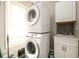 Bright laundry room, featuring stacked washer and dryer, and a convenient utility sink at 2107 Penrose Dr, Atlanta, GA 30344