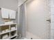 White tiled shower with black and white striped curtain at 2107 Penrose Dr, Atlanta, GA 30344