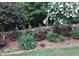 Landscaped backyard with blooming flowers and trees at 7570 Weston Club Dr, Suwanee, GA 30024