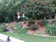 Landscaped backyard with lush greenery and bird feeders at 7570 Weston Club Dr, Suwanee, GA 30024