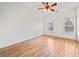 Hardwood floor bedroom with two windows at 7570 Weston Club Dr, Suwanee, GA 30024