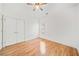 Bright bedroom featuring hardwood floors and double doors at 7570 Weston Club Dr, Suwanee, GA 30024