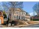 Brick two-story house with a landscaped yard and attached two-car garage at 7570 Weston Club Dr, Suwanee, GA 30024