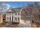 Brick two-story house with gray shutters, attached two-car garage, and landscaping at 7570 Weston Club Dr, Suwanee, GA 30024