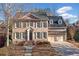 Brick two-story house with gray shutters, attached two-car garage, and landscaping at 7570 Weston Club Dr, Suwanee, GA 30024