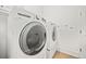 Bright laundry room with washer and dryer at 7570 Weston Club Dr, Suwanee, GA 30024