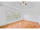 Main bedroom with hardwood floors, plantation shutters, and high ceilings at 7570 Weston Club Dr, Suwanee, GA 30024