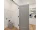 Convenient laundry room with light hardwood floors and wire shelving at 1237 Memorial Se Dr # 403, Atlanta, GA 30316