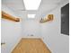 Unfinished basement with wood floors and shelving at 3036 Vinings Ferry Se Dr, Atlanta, GA 30339