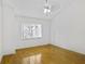 Bright bedroom features wood floors, a ceiling fan, and a large window at 3036 Vinings Ferry Se Dr, Atlanta, GA 30339