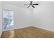 Bright bedroom features wood floors, a ceiling fan, and a large window at 3036 Vinings Ferry Se Dr, Atlanta, GA 30339