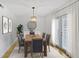 Charming dining room with modern lighting, wood table, and access to the outdoor area at 3036 Vinings Ferry Se Dr, Atlanta, GA 30339