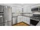 Renovated kitchen with stainless steel appliances, modern cabinets, and stone countertops at 3036 Vinings Ferry Se Dr, Atlanta, GA 30339