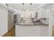 Updated kitchen with white cabinets, stainless steel appliances, and stylish backsplash at 3036 Vinings Ferry Se Dr, Atlanta, GA 30339