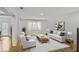 Bright living room with wood floors, white sofa and chairs, and lots of natural light at 3036 Vinings Ferry Se Dr, Atlanta, GA 30339