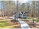 House with a long driveway nestled in a wooded area at 3820 Mink Livsey Rd, Snellville, GA 30039