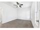 Simple bedroom with ceiling fan, neutral wall paint and carpet flooring at 3820 Mink Livsey Rd, Snellville, GA 30039