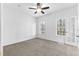 Bedroom with ceiling fan, neutral decor, carpet and access to exterior at 3820 Mink Livsey Rd, Snellville, GA 30039