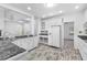 Spacious kitchen boasts white cabinets, granite countertops and a large island at 3820 Mink Livsey Rd, Snellville, GA 30039