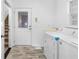 Bright laundry room with washer, dryer, and exterior access at 3820 Mink Livsey Rd, Snellville, GA 30039
