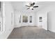 Living room with bay window, ceiling fan, and neutral color palette at 3820 Mink Livsey Rd, Snellville, GA 30039