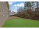 Landscaped backyard with patio and trees at 381 Paper Woods Dr, Lawrenceville, GA 30046