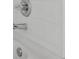 Close-up of a clean bathroom with chrome fixtures and white tile at 381 Paper Woods Dr, Lawrenceville, GA 30046