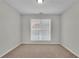 Well-lit bedroom with carpet and a large window at 381 Paper Woods Dr, Lawrenceville, GA 30046