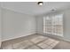 Bright bedroom with neutral walls, carpet flooring, and a large window at 381 Paper Woods Dr, Lawrenceville, GA 30046