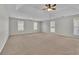 Large carpeted bedroom with multiple windows at 381 Paper Woods Dr, Lawrenceville, GA 30046
