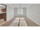 Bright dining room with large windows and neutral carpeting at 381 Paper Woods Dr, Lawrenceville, GA 30046