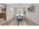 Elegant dining room with a marble table, six chairs, and kitchen views at 381 Paper Woods Dr, Lawrenceville, GA 30046