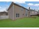 Tan house exterior with a backyard patio at 381 Paper Woods Dr, Lawrenceville, GA 30046