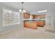 Kitchen with an island, wood cabinets, and stainless steel appliances at 381 Paper Woods Dr, Lawrenceville, GA 30046