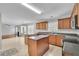 Open kitchen with island, wood cabinets, and tile flooring at 381 Paper Woods Dr, Lawrenceville, GA 30046