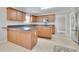 Kitchen boasts wood cabinets, an island, and stainless steel appliances at 381 Paper Woods Dr, Lawrenceville, GA 30046