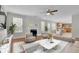 Living room with hardwood floors and fireplace, open to kitchen at 381 Paper Woods Dr, Lawrenceville, GA 30046