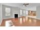 Living room with hardwood floors and fireplace, open to kitchen at 381 Paper Woods Dr, Lawrenceville, GA 30046